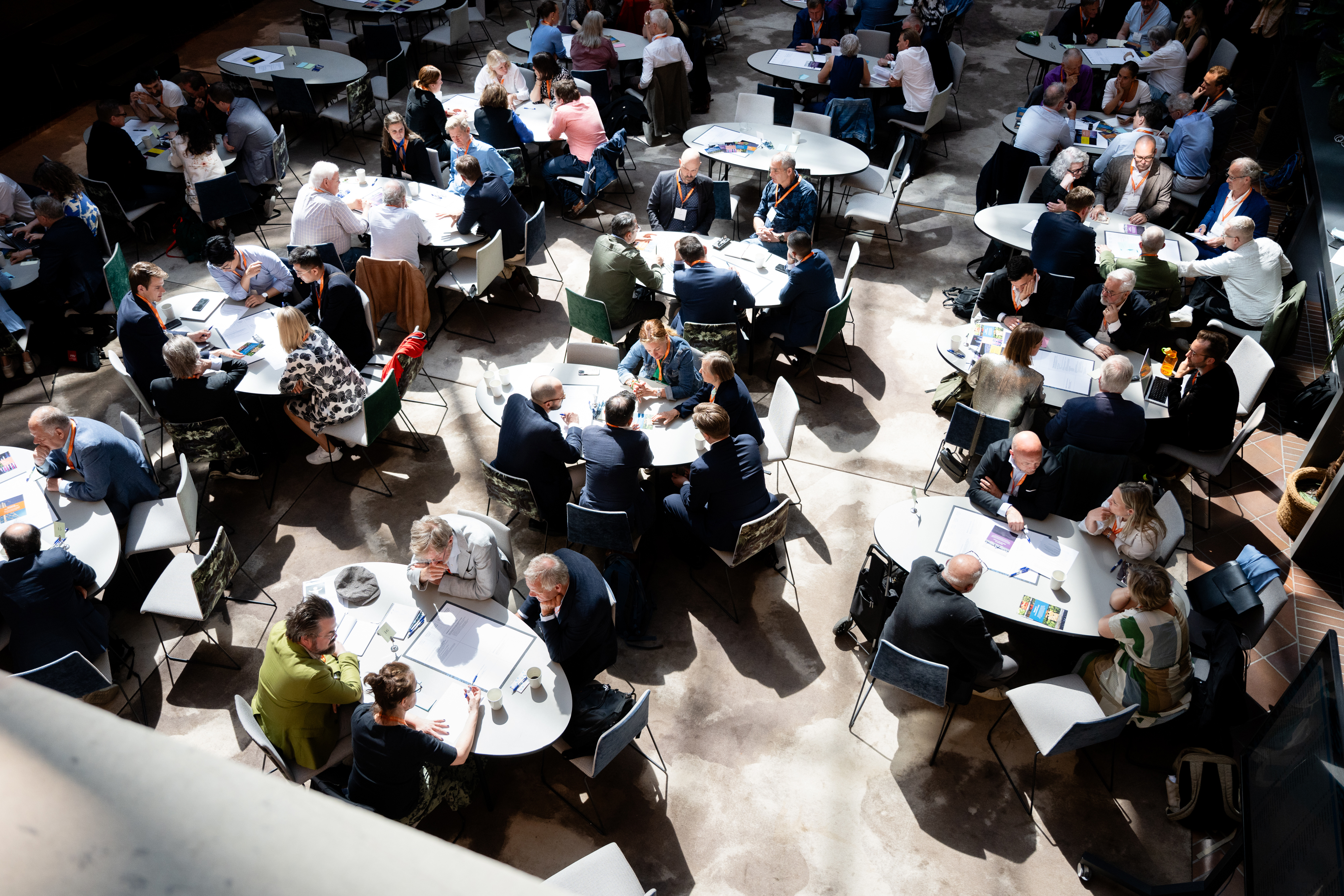 fullsatt sal med samtalande människor